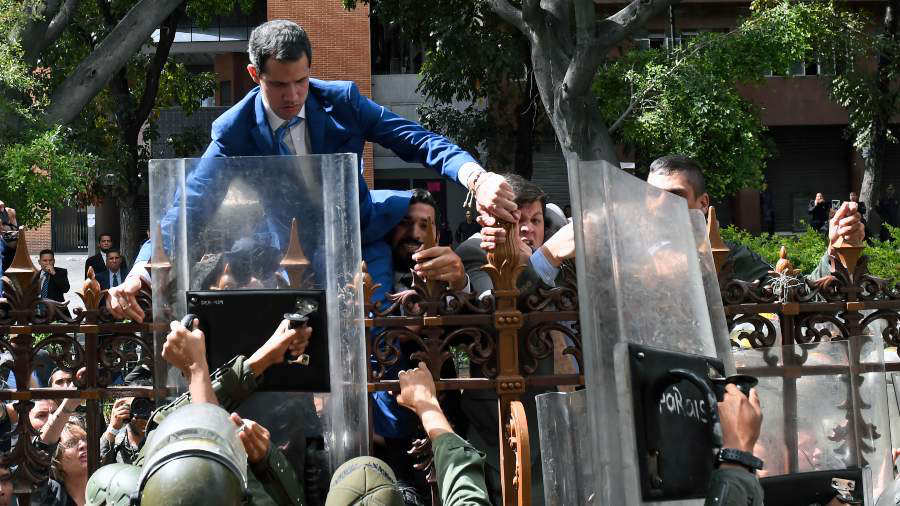 Juan Guaidó attempting to jump the fence