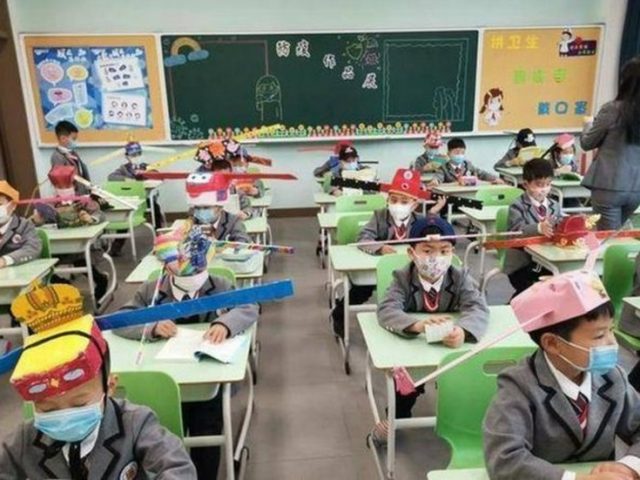 Thinking caps on: Chinese school kids return to classroom with the help of ‘social distancing hats’ (PHOTOS)