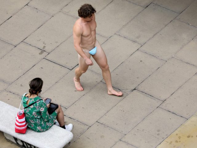 Cheeky protest? Man turns facemask into G-string for walkabout through downtown London (PHOTOS)