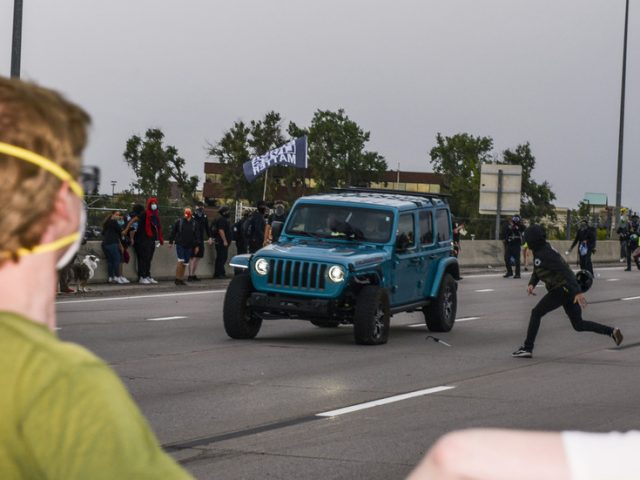 Protester shoots fellow demonstrator while aiming at car that sped through crowd on highway in Aurora, Colorado (VIDEO)