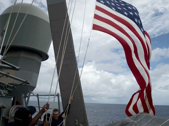 US sends warship past Chinese-controlled South China Sea islands in Biden administration first