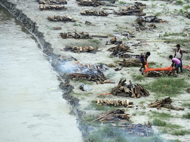 Dozens of bodies, many of them buried Covid victims, are washed from banks of India’s Ganges by seasonal floods & float downriver