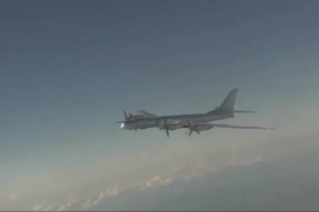 Russian strategic bombers soar through skies as onboard gunners let off anti-aircraft salvos in major military readiness exercises
