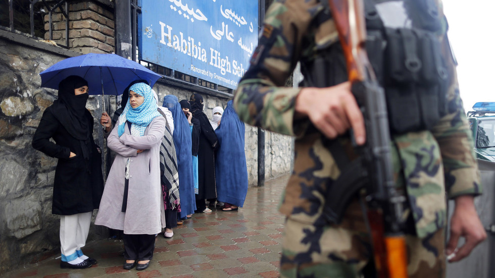 An Afghan policeman stands guard at a polling station in Kabul. Reuters Tim Wimborne