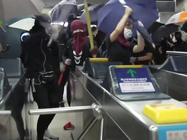 Masked Hong Kong protesters SMASH UP metro station with metal bars and hammers in defiance of emergency order (VIDEO)