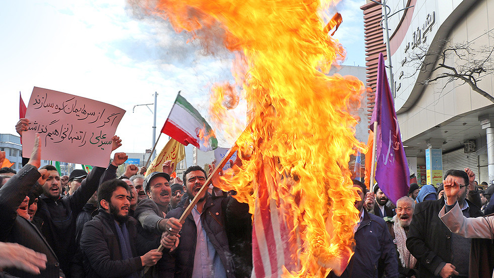 Iranian men burn a US flag