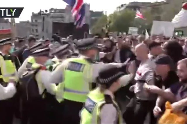 Police engage in SHOVING MATCH with protesters at major rally against coronavirus measures in London (VIDEO)