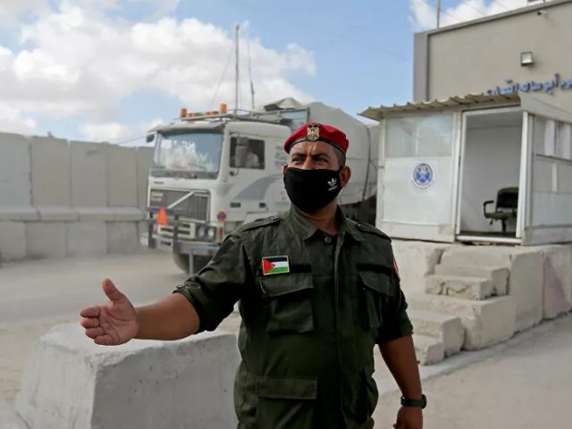 A Palestinian member of Hamas security forces stands outside the main commercial crossing with Gaza, Kerem Shalom, in the southern Gaza strip August 11, 2020. Hamas Announces ‘Deal’ to End Escalation With Israel
