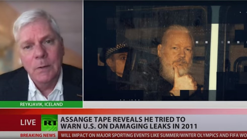 Julian Assange reaching