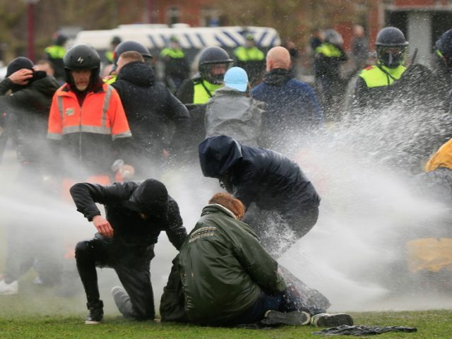 Woman knocked over & left bleeding after water cannon fires from close range during anti-lockdown protests in Netherlands (VIDEO)