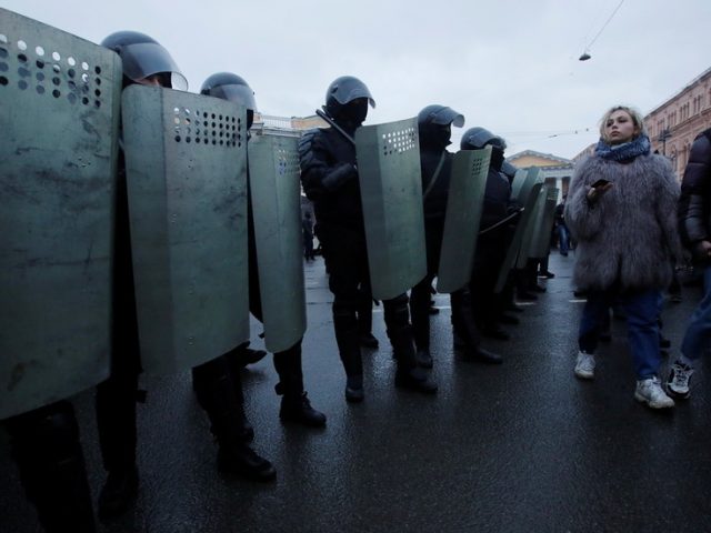 Riot cop visits hospital to apologize to woman he kicked in stomach during intense protests in St. Petersburg