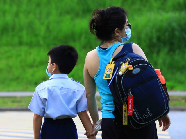 Singapore closes schools over concern that new Covid strains ‘attack the younger children’