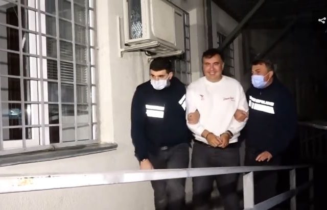 WATCH handcuffed ex-President Saakashvili taken to Georgian jail as prosecutors vow to put him behind bars for AT LEAST 6 years